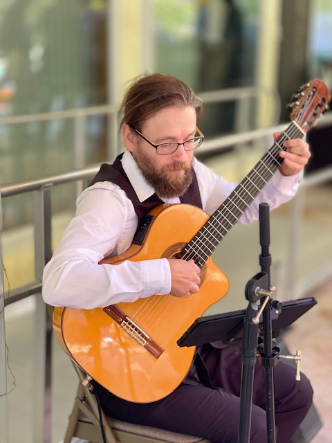 John H. Clarke performing at backyard party in Palo Alto, CA